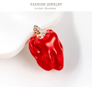 Détail de pendentif piment rouge avec fermoir doré et pierres de cristal étincelantes