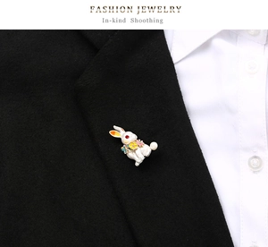 Creative rabbit brooch with white enamel and pearl on a black suit lapel detail