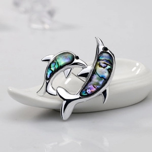 Elegant dolphin brooch featuring natural abalone shell inlay and silver metal finish