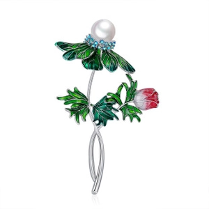 Detailed macro view of a floral enamel brooch featuring a white pearl and blue crystals