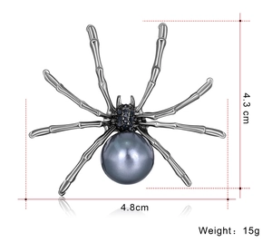 Detailed view of spider brooch with dimensions 4.8cm by 4.3cm and large pearl inlay