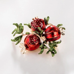 Vintage pomegranate brooch featuring red enamel and gold-plated metal fruit clusters
