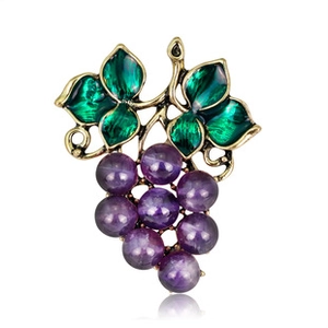 Detail of grape brooch with purple beads, green enamel leaves and golden frame