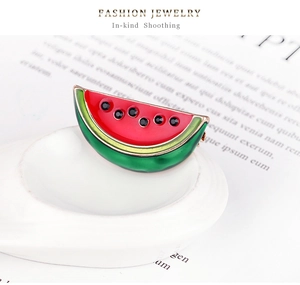 Macro shot of watermelon brooch with enamel layers and black rhinestones for suits
