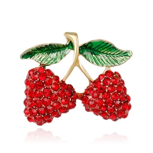 Detailed view of cherry brooch featuring sparkling red rhinestones and green enamel leaves