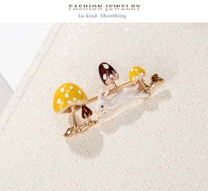 Detail of bunny and colorful mushroom brooch with gold finish enamel in high quality view