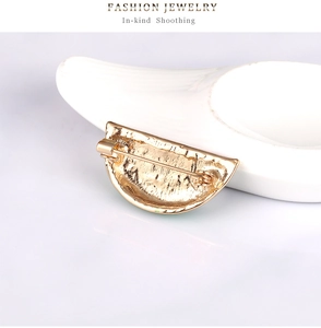 Detailed back view showing the golden alloy clasp and pin of the watermelon brooch
