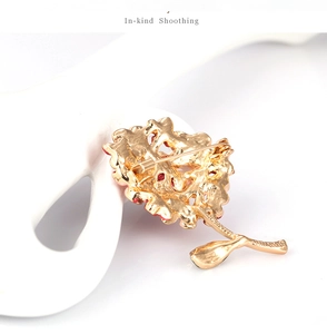 Detail view of the secure metal pin fastener on the back of the golden flower brooch