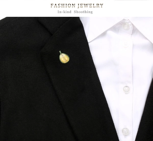 Fashionable durian brooch with yellow and green enamel details pinned on a black suit lapel