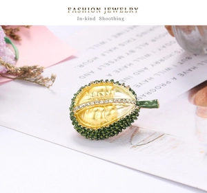 Close-up of durian brooch with gold pulp, green shell and fine rhinestone inlay detail