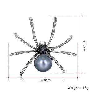 Exaggerated fashion spider brooch featuring dark gunmetal finish and large grey pearl bead
