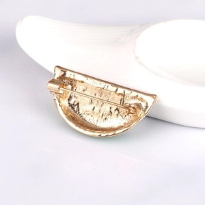 Minimalist gold metal fruit brooch back view featuring a secure pin fastening mechanism
