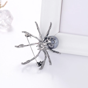 Spider insect brooch with grey pearl and dark gunmetal legs on a white frame