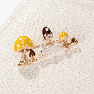 Exquisite rabbit and mushroom enamel brooch with gold alloy base on white background