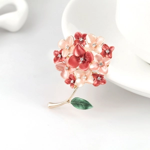 Elegant floral bouquet brooch with pink enamel petals, green leaf, and crystal center