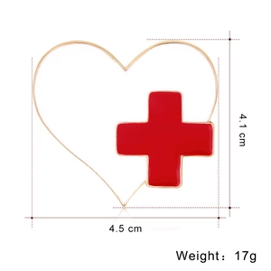 Detail view showing a gold heart-shaped medical brooch with dimensions 4.5 cm by 4.1 cm