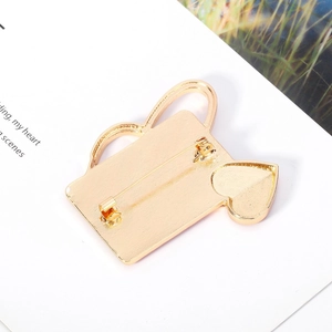 Detail of medical brooch back with gold alloy texture and secure pin fastening