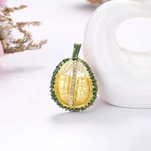 Exaggerated durian fruit brooch with yellow enamel and sparkling white rhinestones