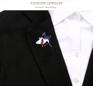 Detailed view of cartoon shark enamel brooch pinned on a black suit lapel