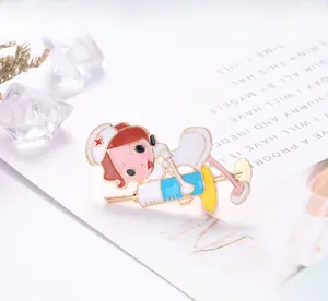 Close-up of a cute nurse enamel brooch with syringe, creative alloy lapel pin detail