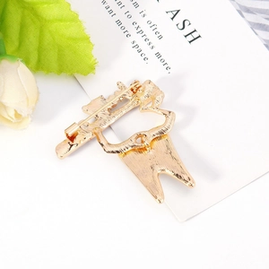 Detail of the golden metal brooch back view with a sturdy safety pin closure