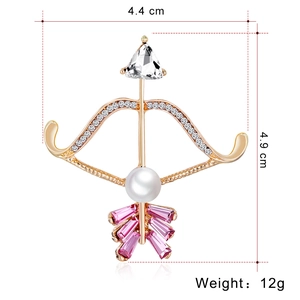 Pink crystal and pearl bow arrow brooch in gold metal finish, size 4.4cm x 4.9cm