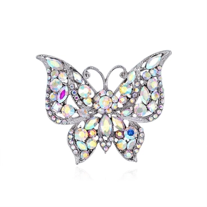 Vintage butterfly brooch in silver alloy with colorful rhinestones on white background