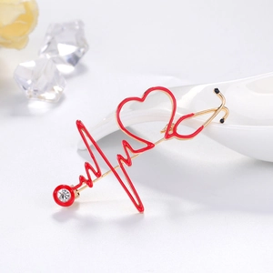 Medical brooch with golden stethoscope heart and red EKG line plus sparkling zircon