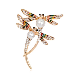 Detailed view of dragonfly brooch with pearls and colorful enamel wings