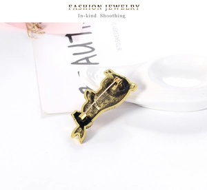 Detail view of the vintage rabbit brooch back showing secure safety pin clasp closure