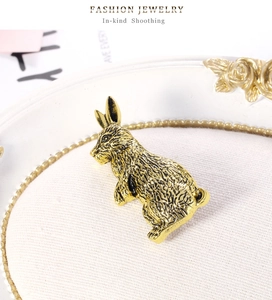 Macro detail of vintage gold rabbit brooch showing fine fur texture and antique finish