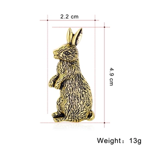 Vintage gold rabbit brooch with textured fur detail and size measurements 2.2x4.9 cm