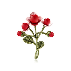 Detailed view of floral branch brooch with pink petals, green leaves and red beads