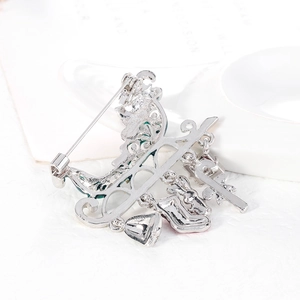 Silver alloy Christmas brooch featuring festive charms and a secure pin on back
