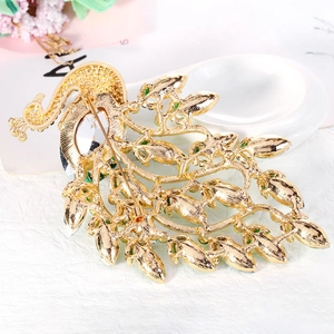 Vintage green peacock brooch in gold alloy with crystal rhinestones and safety pin back