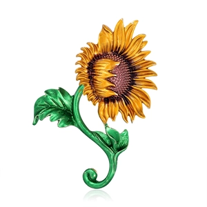 Broche tournesol éclatante avec pétales orange et feuilles vertes sur fond blanc poli