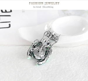 Detailed back view of silver beetle brooch showing secure long pin and colorful gems