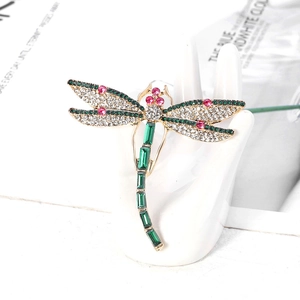 Exquisite gold dragonfly brooch with green emerald gems and sparkling white rhinestones