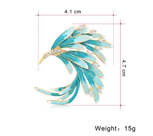 Macro shot of phoenix brooch with blue gradient enamel and size dimensions 4.1cm by 4.7cm