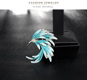 Detail of blue and white enamel phoenix brooch with rhinestones on a display stand