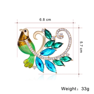 Élégante broche phénix verte avec strass colorés sur une base plaquée en or