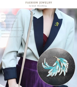 Detail of elegant phoenix feather brooch with blue enamel and white marquise zircons