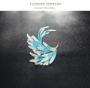 Detail of blue phoenix wing brooch with enamel finish and sparkling zircon accents