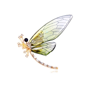 Detailed macro view of dragonfly brooch with green gradient wings and white zircon stones