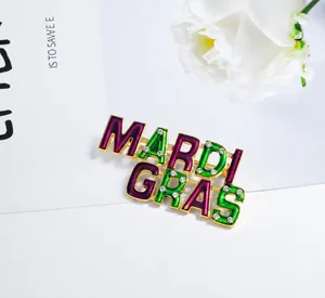 Detailed view of Mardi Gras enamel brooch with purple green colors and white rhinestones