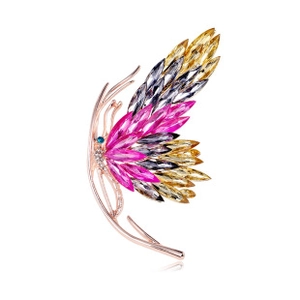 Close-up of butterfly brooch with pink and yellow crystals on rose gold base
