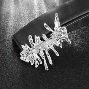 Artistic silver irregular fluid metal brooch with high polish finish on dark leather