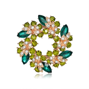 Elegant rose gold floral wreath brooch with emerald and forest green crystals