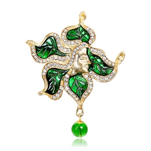 Detail of vintage cactus brooch with green enamel leaves, white rhinestones and a cameo