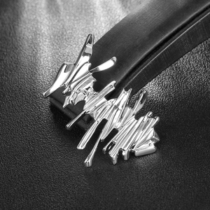 Minimalist silver liquid metal brooch with abstract irregular fluid design for women